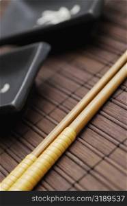 Close-up of two chopsticks on a mat