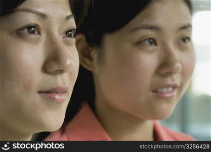 Close-up of two female office workers looking away