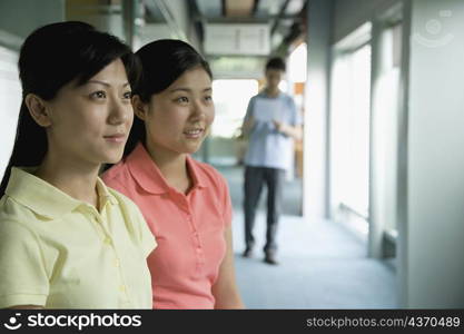 Close-up of two female office workers looking away