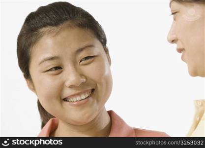 Close-up of two female office workers smiling