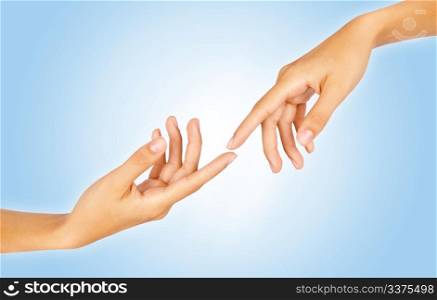 Close-up of two finger tips reaching out each other over gradient blue background