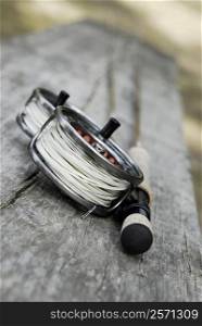 Close-up of two fishing reels and a fishing rod