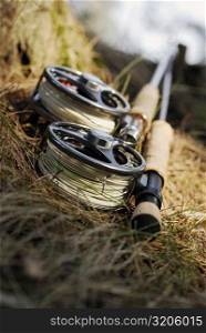 Close-up of two fishing reels and two fishing rods