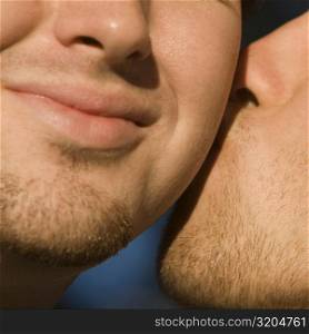 Close-up of two gay men kissing