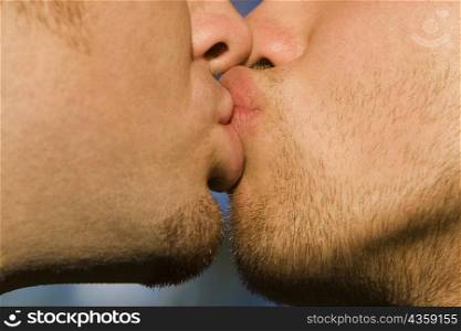 Close-up of two gay men kissing