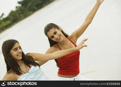 Close-up of two girls dancing on the beach