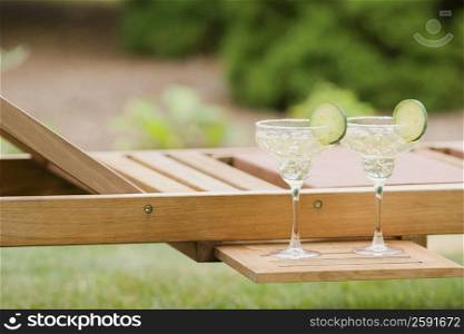 Close-up of two glasses of lemonade on a lounge chair