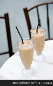 Close-up of two glasses of milkshake on the table