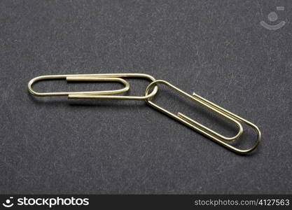 Close-up of two interlocked paper clips