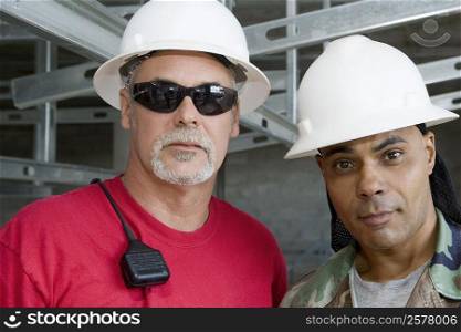 Close-up of two male construction workers at a construction site