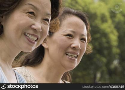 Close-up of two mature women smiling