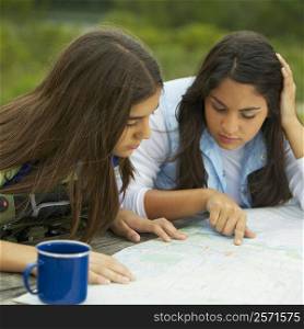 Close-up of two mid adult women looking at a map