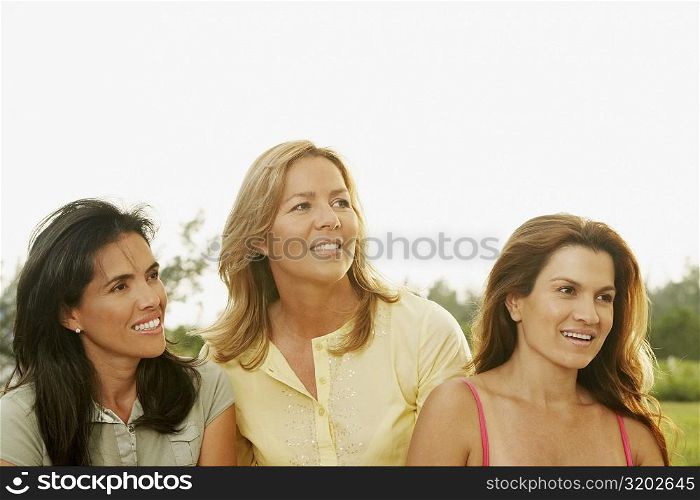 Close-up of two mid adult women with a mature woman looking away
