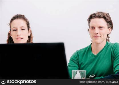 Close-up of two office worker sitting watching the laptop