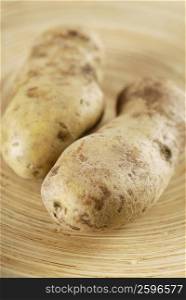 Close-up of two raw potatoes