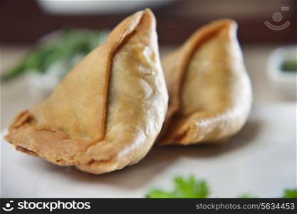 Close-up of two samosas in plate