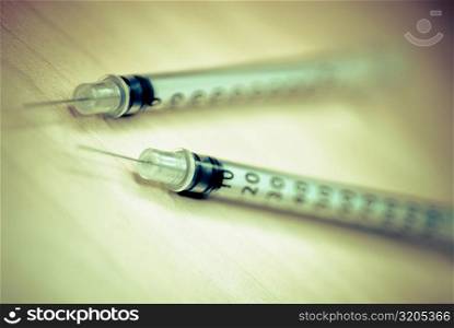 Close-up of two syringes