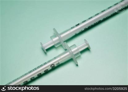 Close-up of two syringes