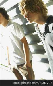 Close-up of two teenage boys standing together