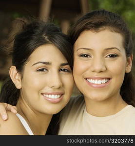 Close-up of two teenage girls smiling