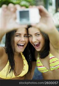 Close-up of two teenage girls taking a picture of themselves