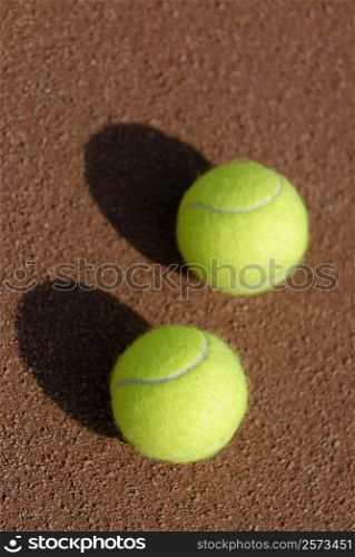 Close-up of two tennis balls on a tennis court