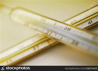 Close-up of two thermometers