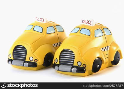 Close-up of two toy taxis parked side by side