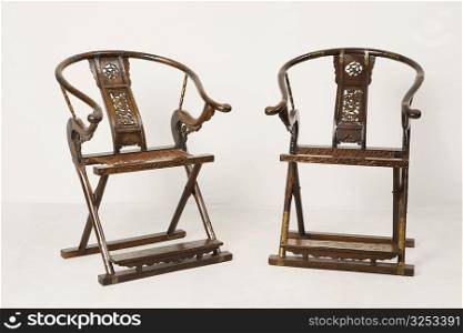 Close-up of two wooden folding chairs