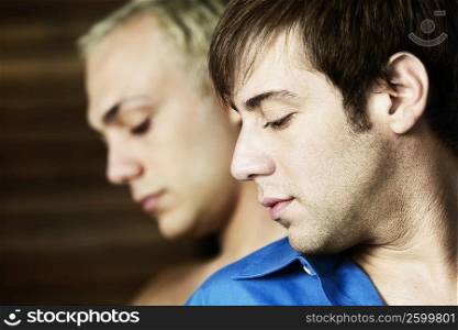 Close-up of two young men looking pensive
