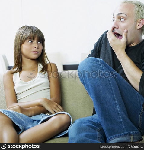 Close-up of two young men teasing a girl