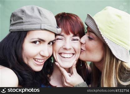 Close-up of two young women and a mid adult woman smiling
