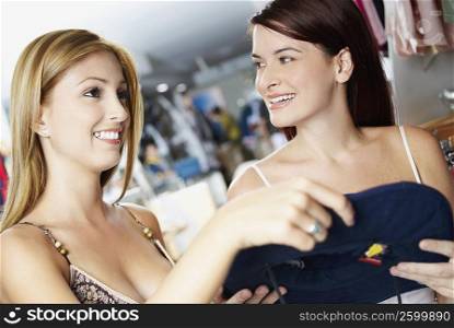 Close-up of two young women choosing clothes in a clothing store