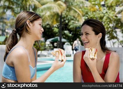 Close-up of two young women eating sandwiches