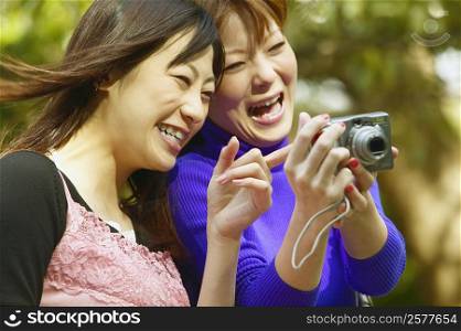 Close-up of two young women laughing