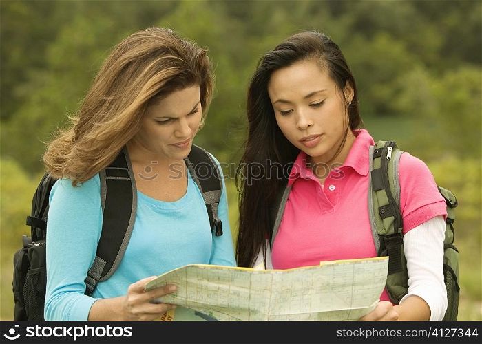 Close-up of two young women looking at a map