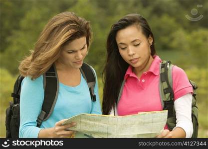 Close-up of two young women looking at a map