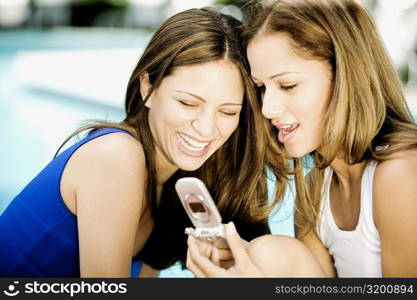 Close-up of two young women looking at a mobile phone