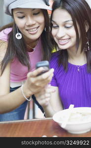 Close-up of two young women looking at a mobile phone