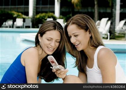 Close-up of two young women looking at a mobile phone