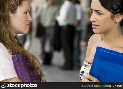 Close-up of two young women looking at each other