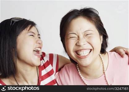 Close-up of two young women looking cheerful