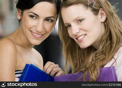 Close-up of two young women smiling together