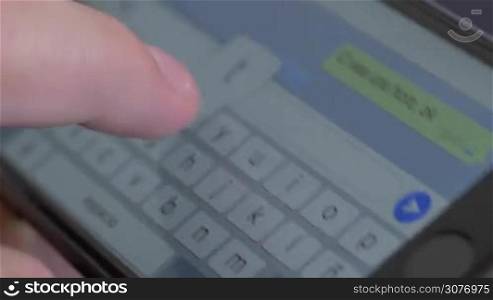 Close up of typing a text message horizontally on a smartphone