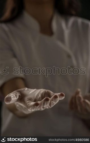 Close up of unrecognizable female doctor holding something in her hands