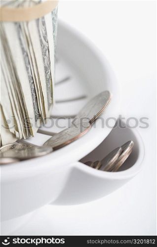 Close-up of US dollar bills and currency in a juicer