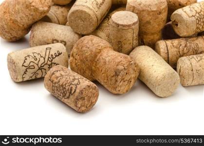 Close up of used assorted wine corks on white