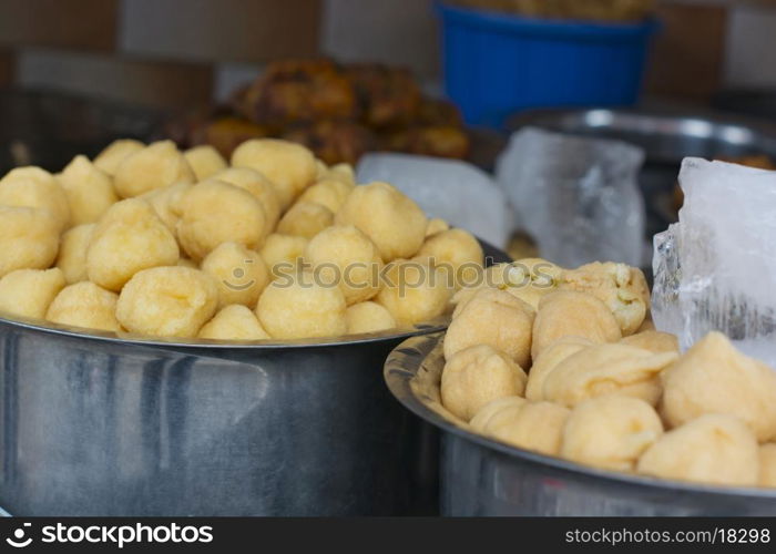 Close-up of vadas in containers at stall