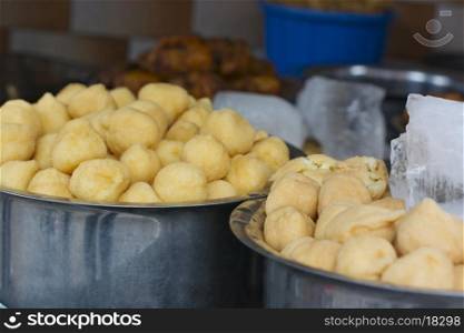 Close-up of vadas in containers at stall