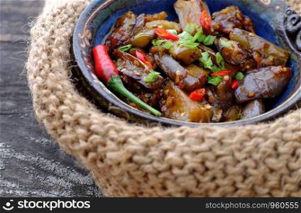 Close up of vegan food in bowl, eggplant cook with soy sauce, a simple food for Vietnamese vegetarian meal but delicious, healthy.